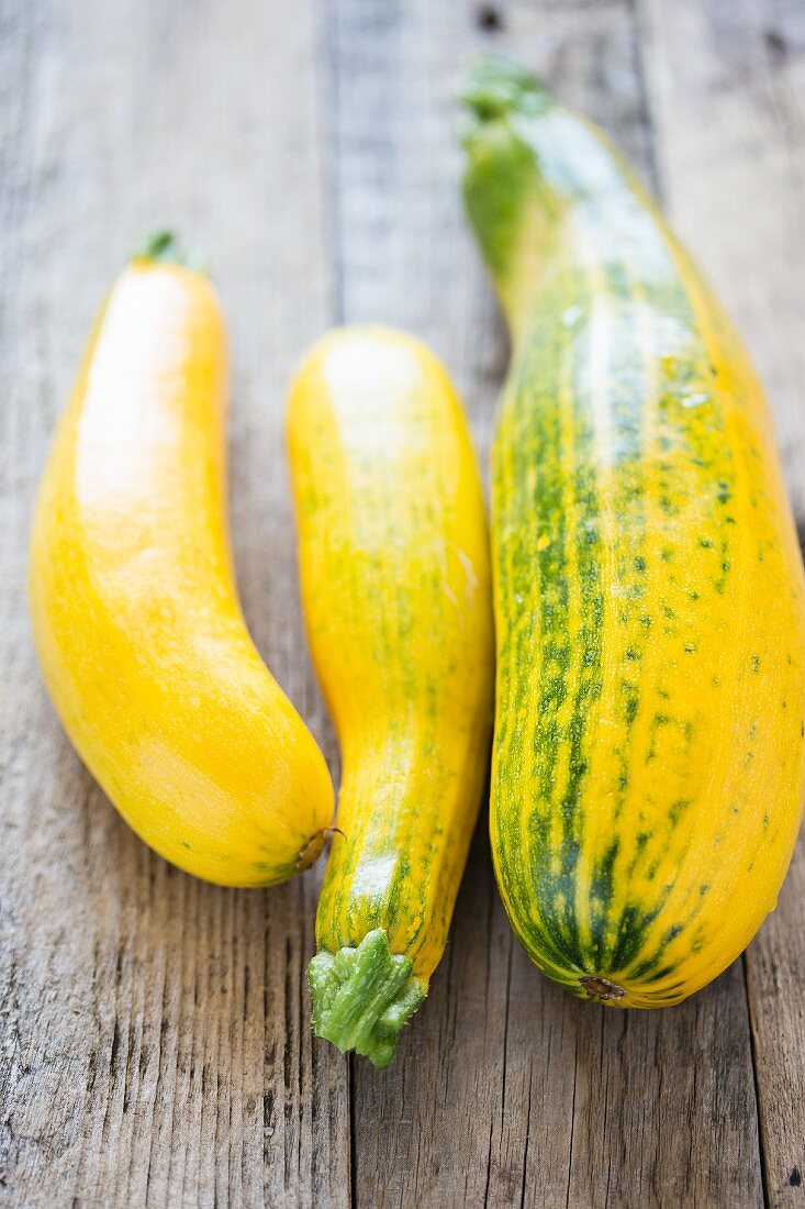 Yellow courgettes on a wooden surface