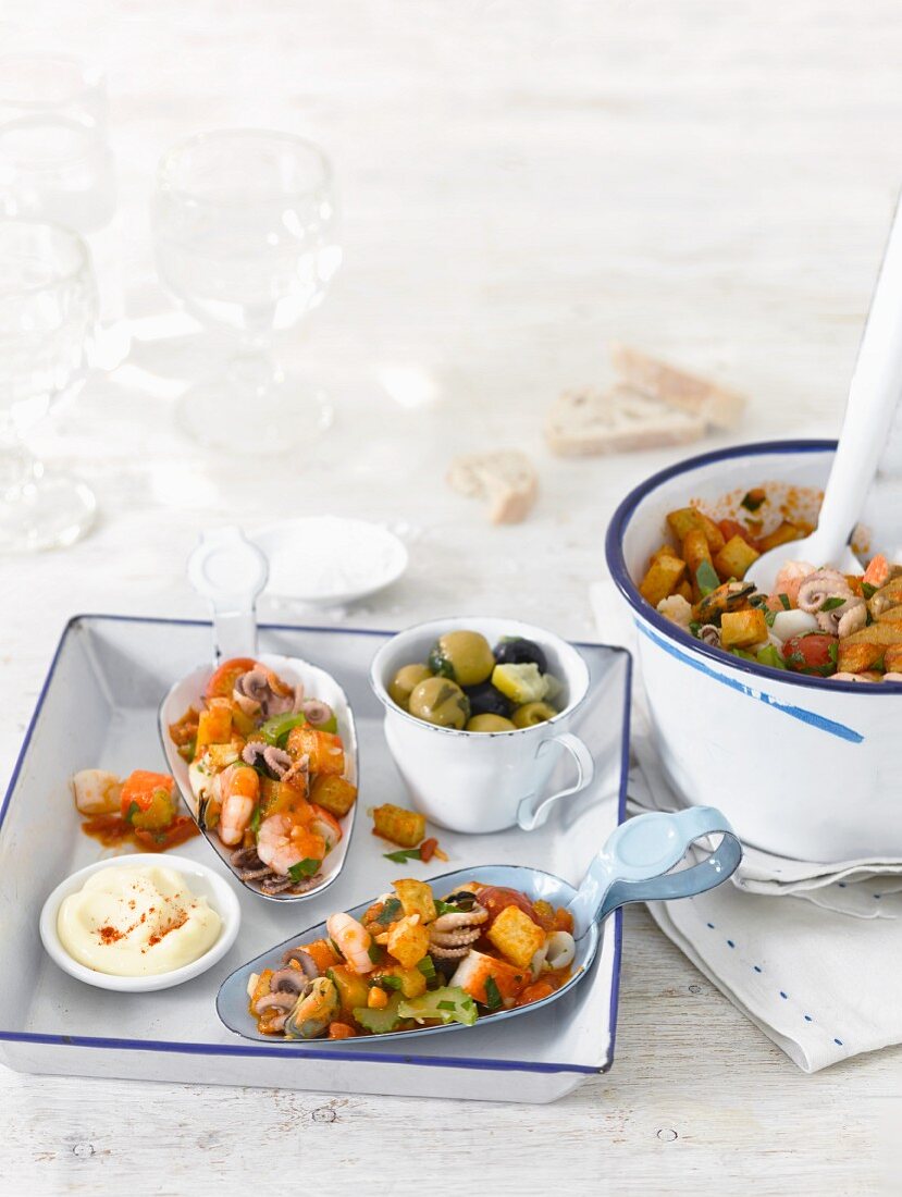 Seafood tapas with crispy potatoes, olives and aioli