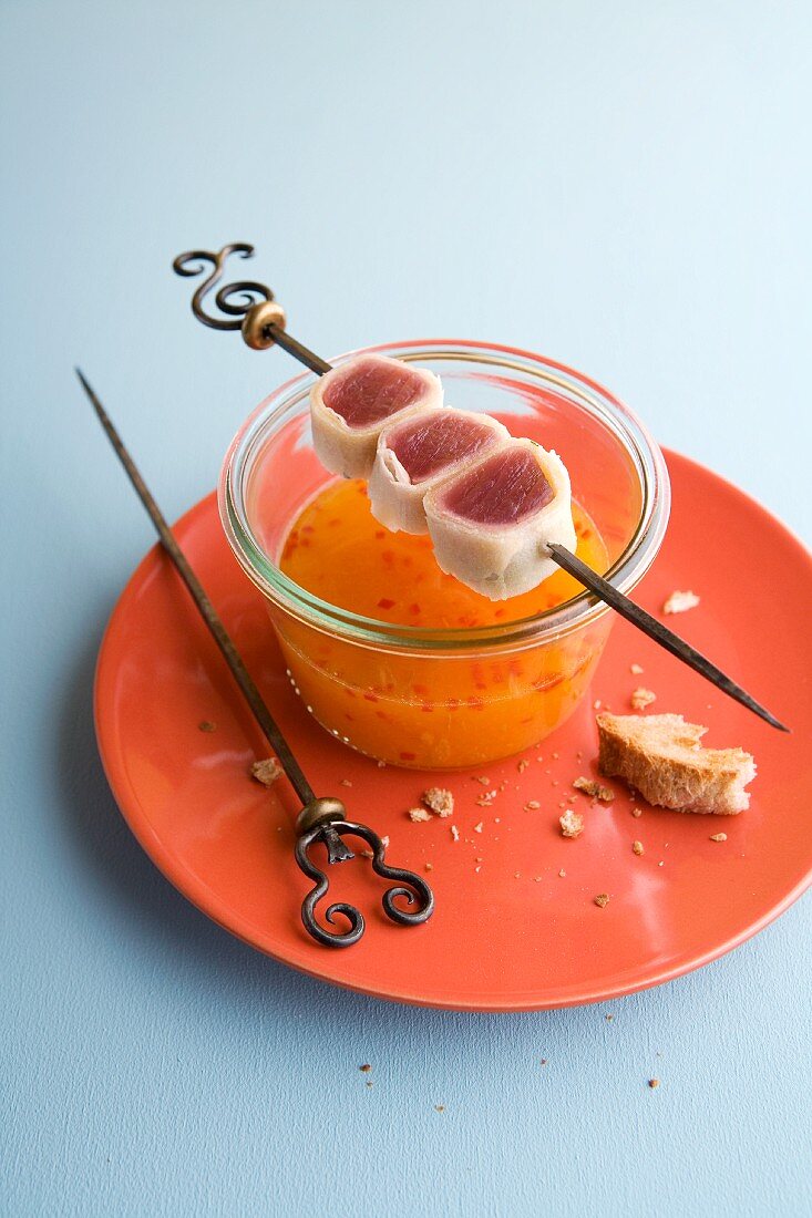 Crispy tuna fish rolls on a skewer over Cavaillon melon soup