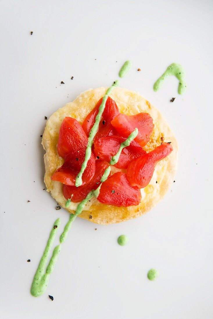 A mini tomato pizza with goat's cheese coriander pesto