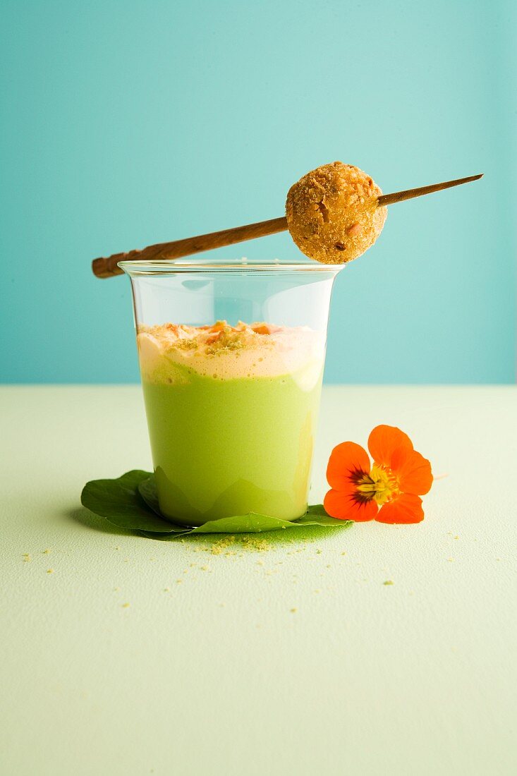 Wasabi soup with peas, carrot foam and a squid rice ball