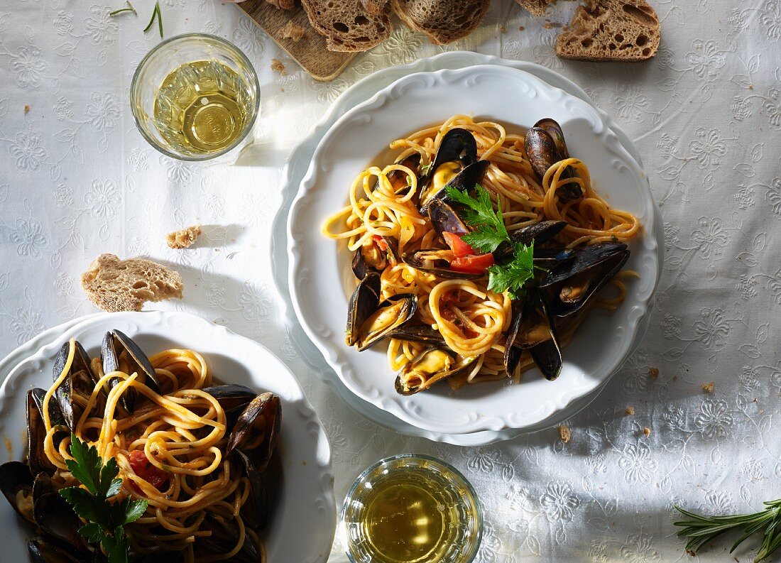 Spaghetti with mussels, white wine and bread (seen from above)