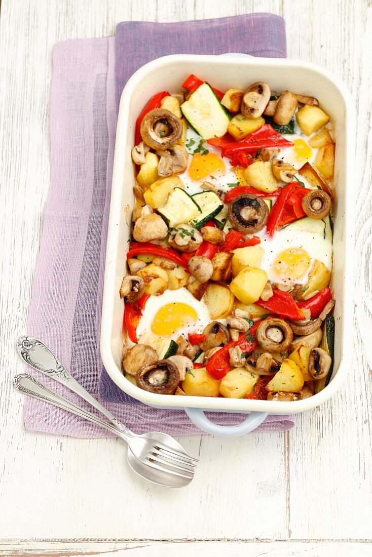 Oven-baked, eggs with potatoes, courgettes, mushrooms and peppers