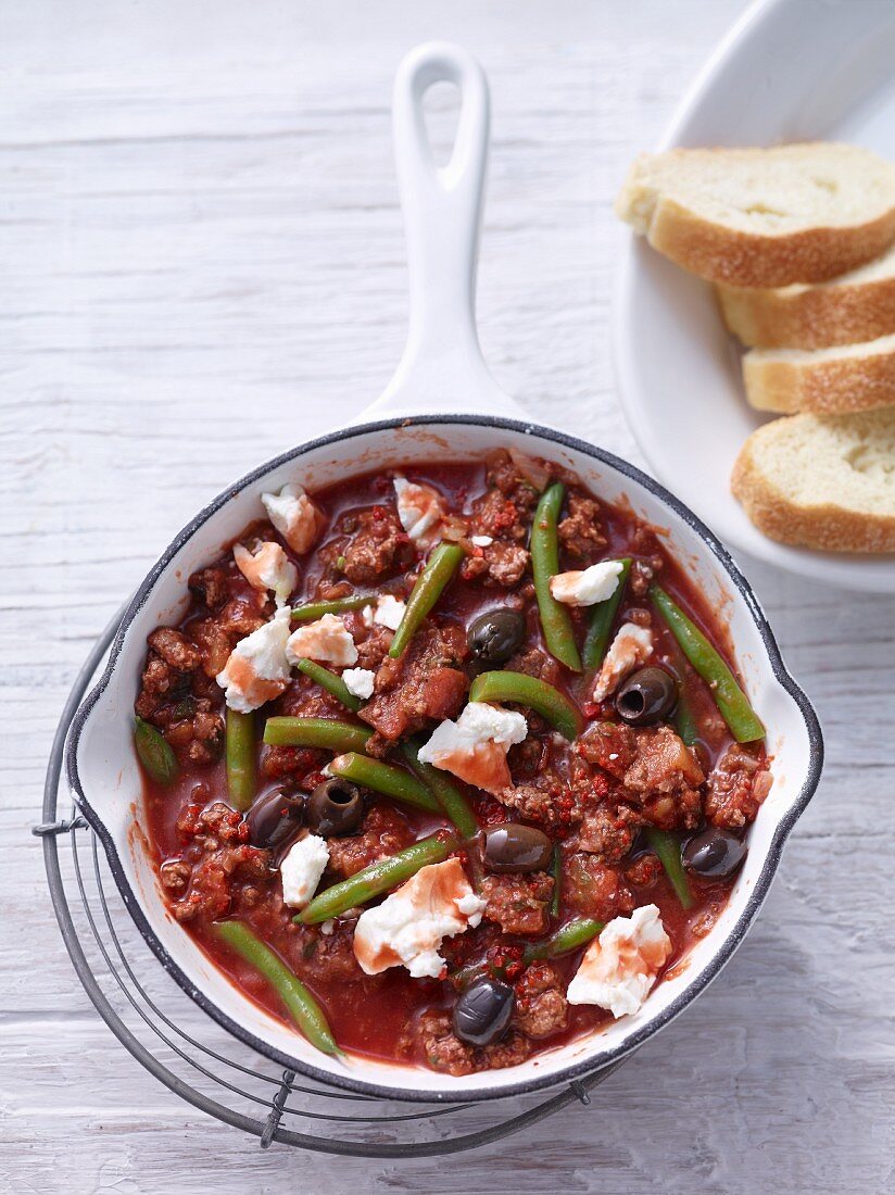 Fried minced meat with beans, olives and sheep's cheese