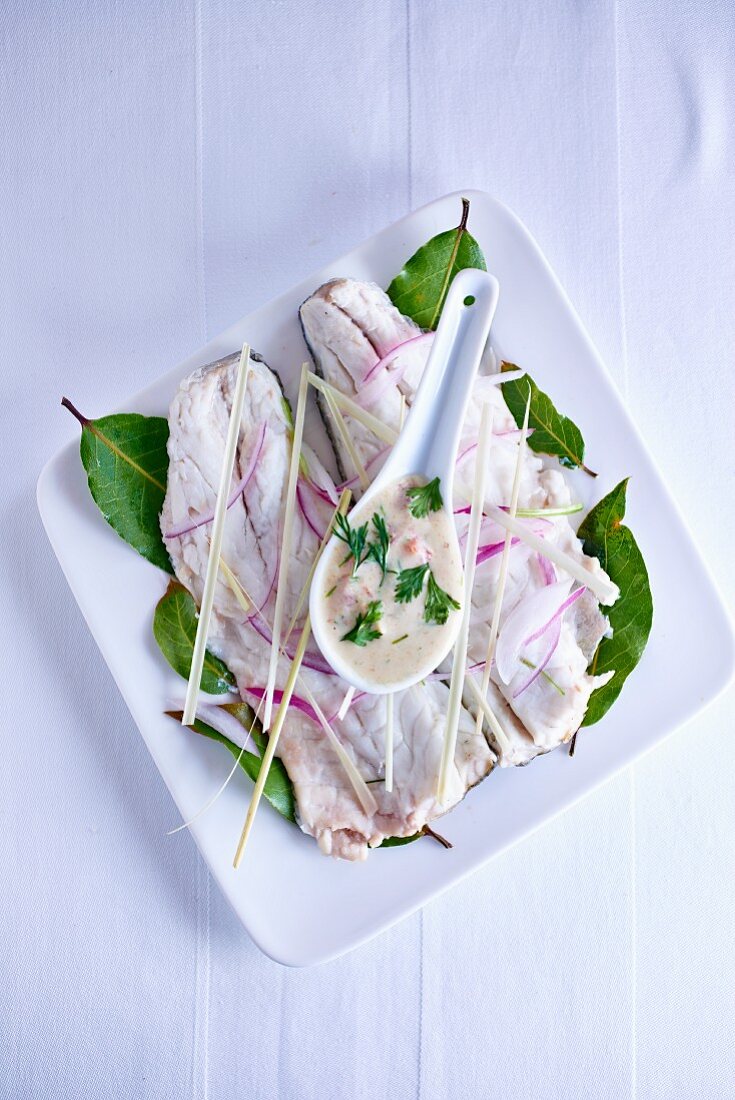 Branzini fillets with onions, lemongrass and coconut sauce