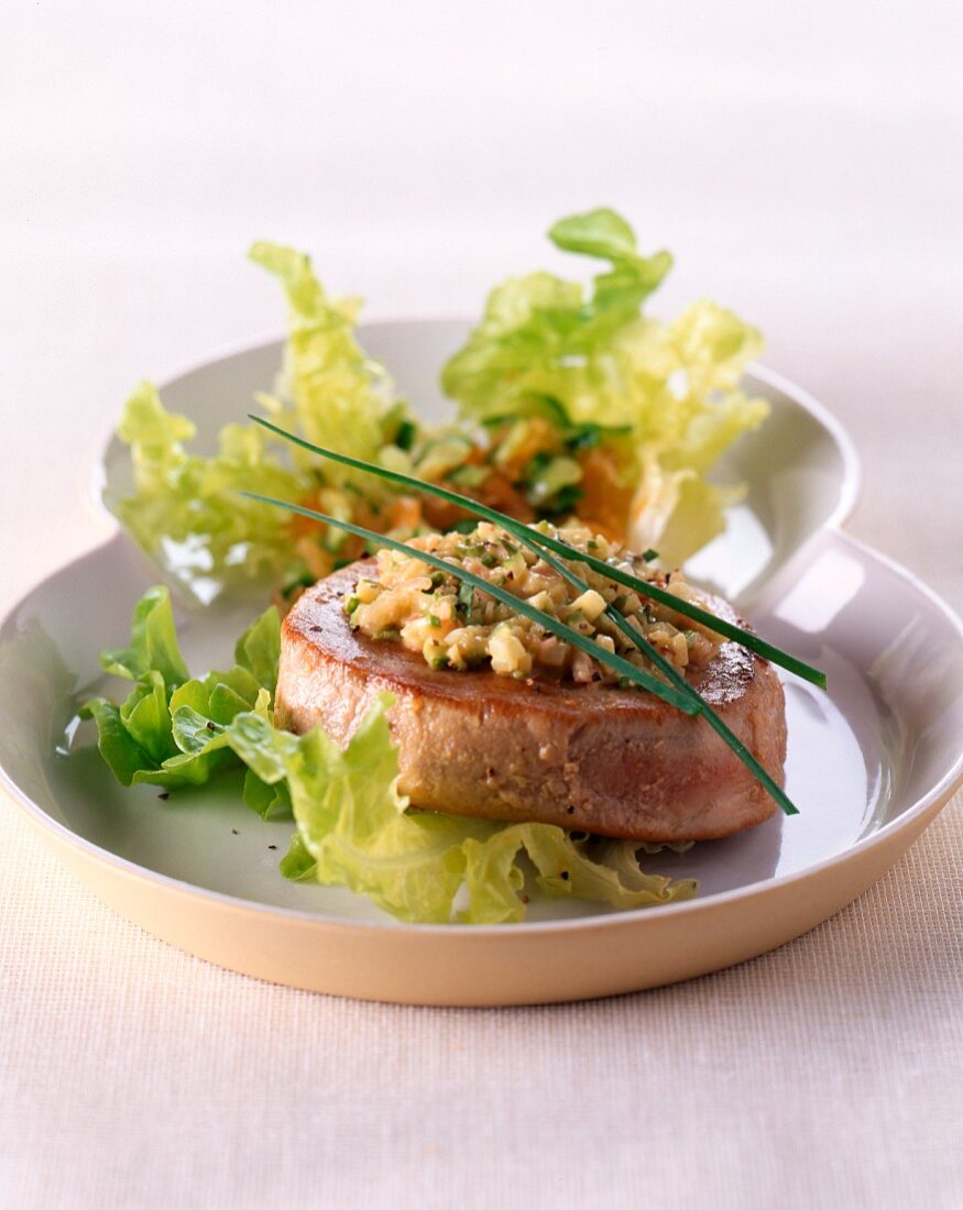 Tuna fish fillet on a mixed leaf salad