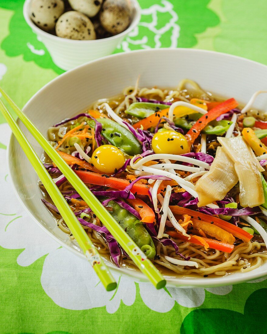Stock with ramen noodles, colourful vegetables and quail's eggs (Asia)