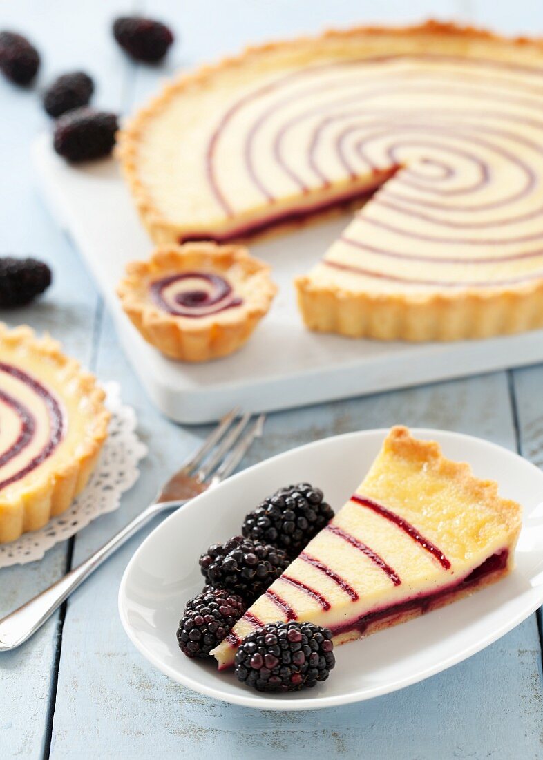 Blackberry and vanilla pudding tart, sliced