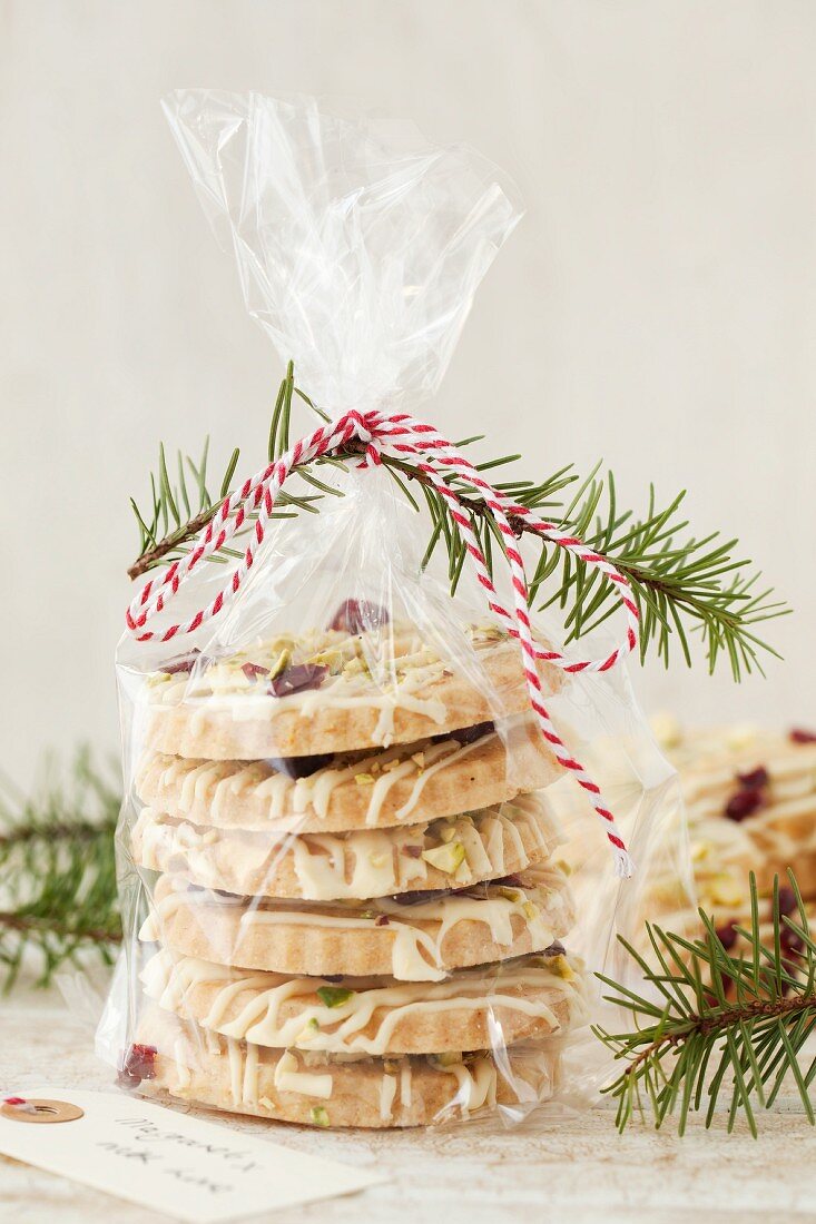 White chocolate biscuits with pistachios and cranberries in a cellophane bag as a gift