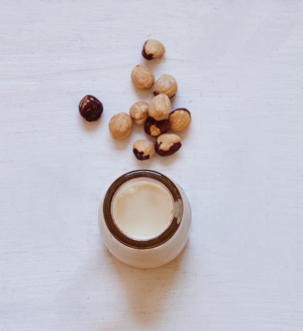 Hazelnuts and a bottle of hazelnut milk