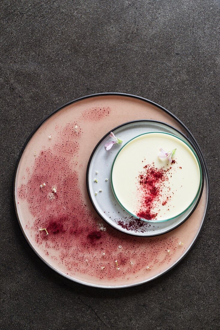 Pelargonian panna cotta with beetroot powder and edible flowers