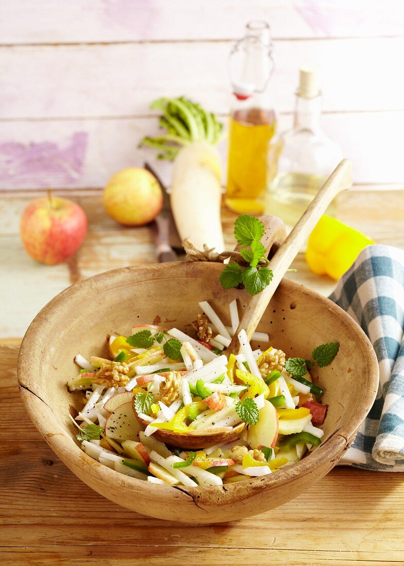 Colourful radish salad with apples and walnuts