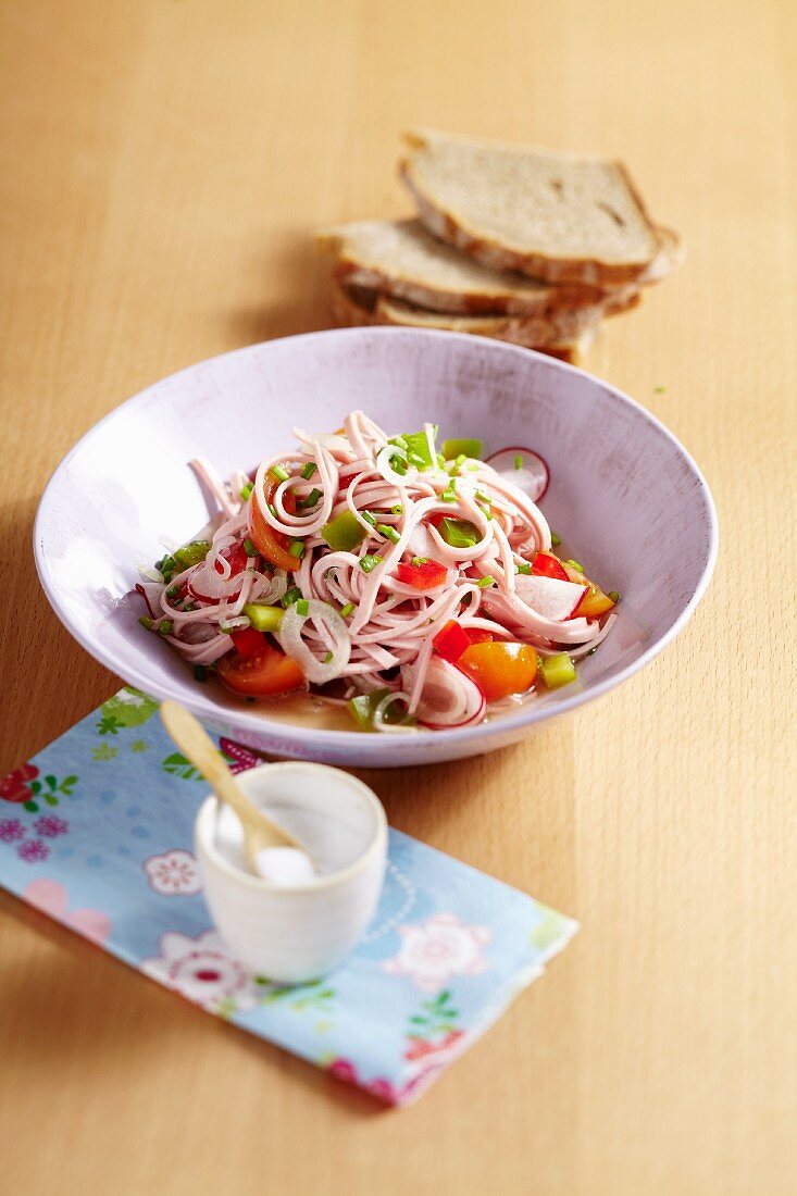 Sausage salad with pepper and radishes