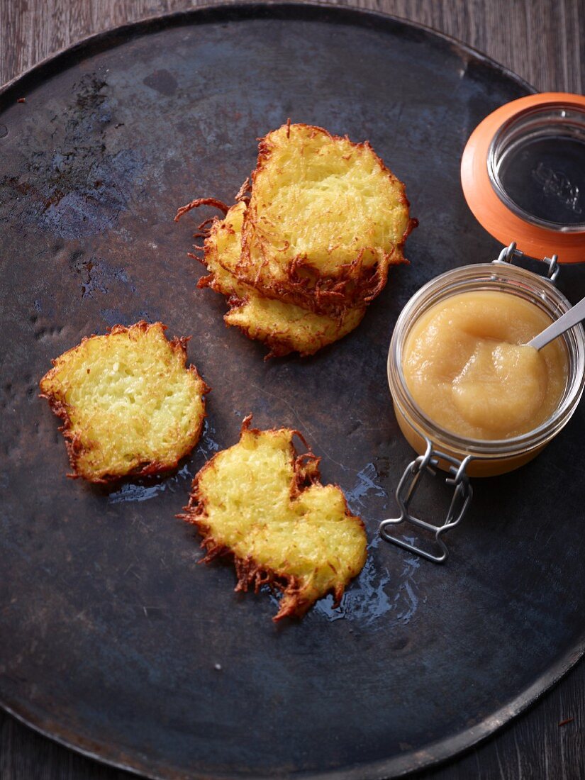 Potato fritters with apple sauce in a flip-top jar