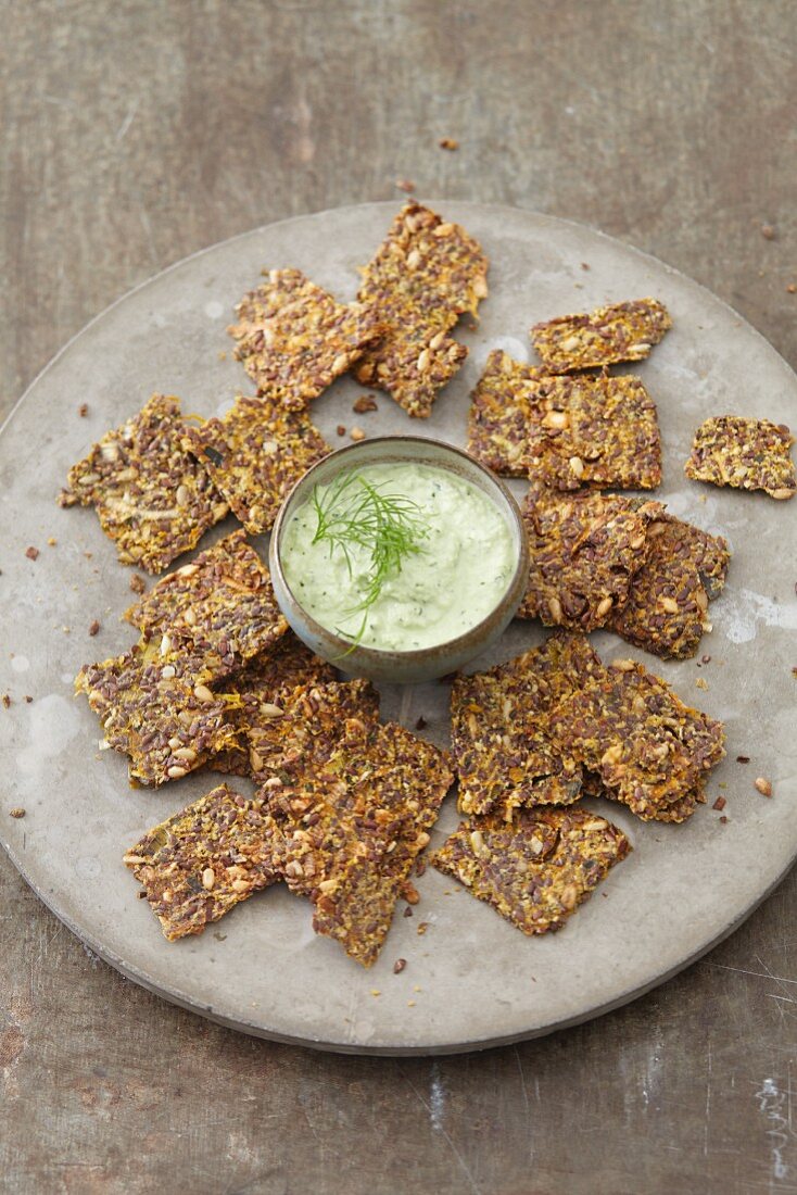 Vegan sunflower crackers with an almond and algae dip