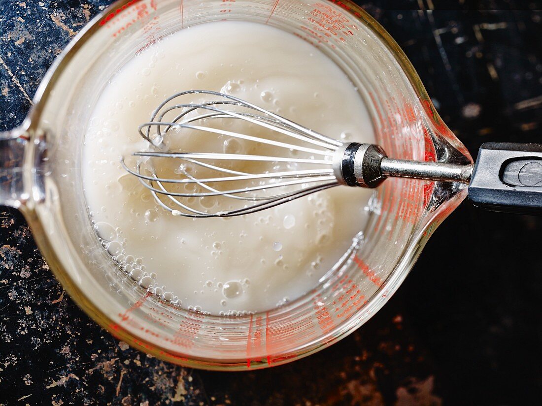 Fresh baking yeast being dissolved in water for making yeast dough