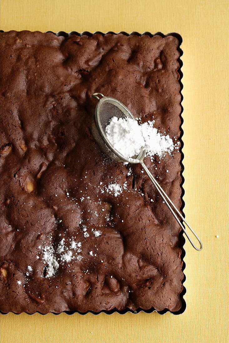 Chocolate and ginger brownie with apples and icing sugar