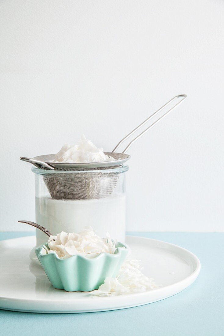 Homemade coconut milk with coconut flakes