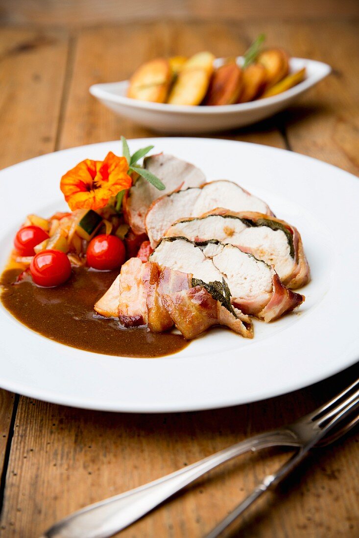 Chicken saltimbocca with cherry tomatoes and roast potatoes