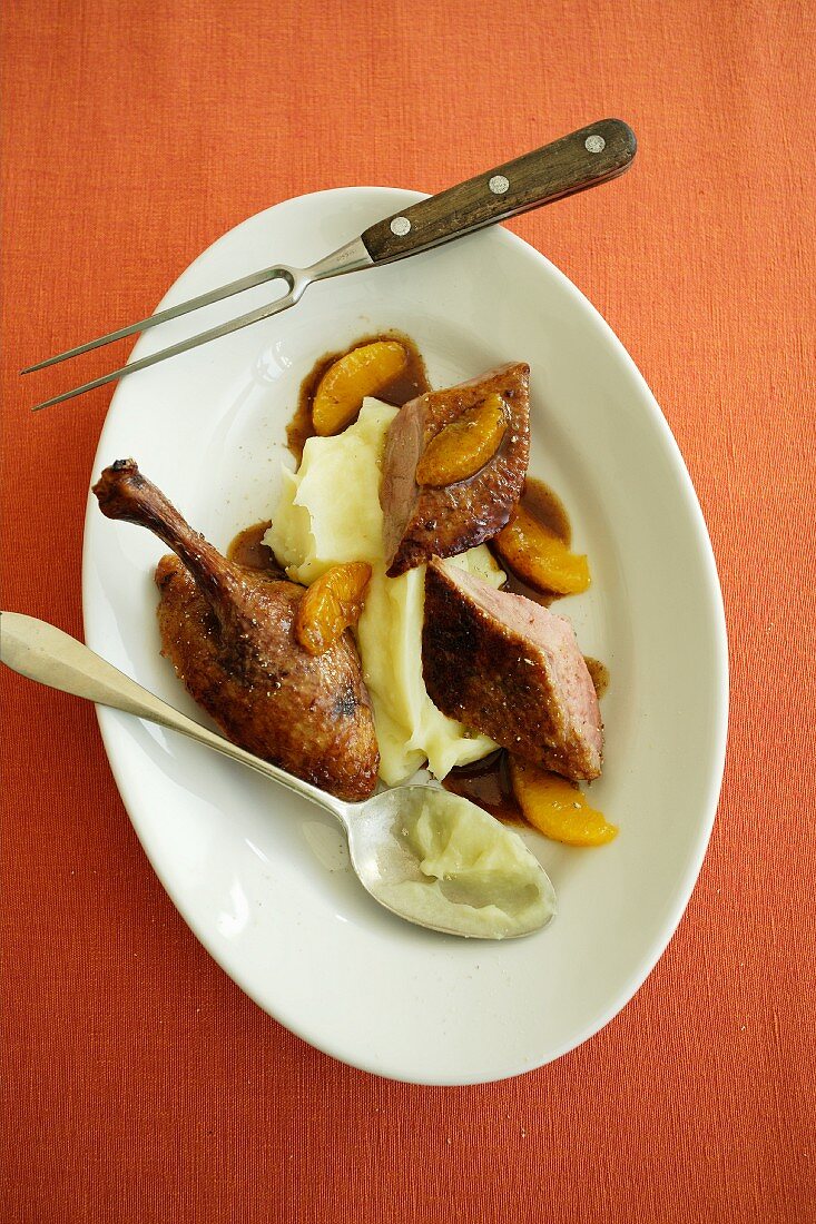 Roast duck with an orange and ginger sauce with mashed potatoes