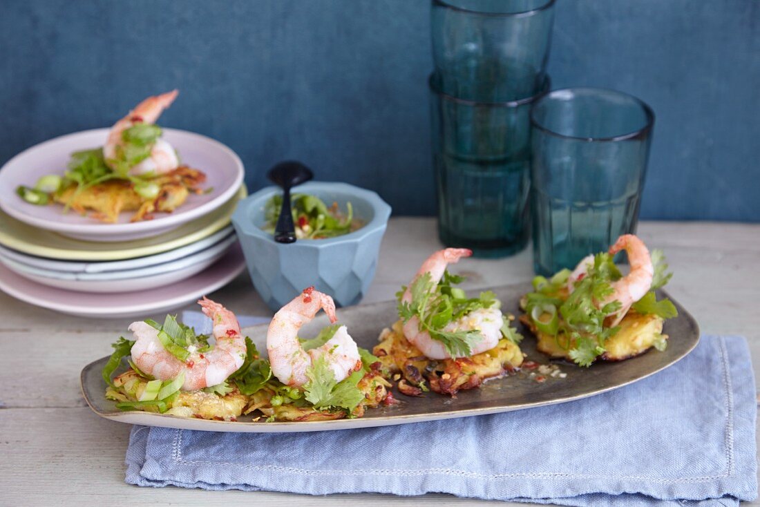 Mini potato fritters with prawns, coriander and limes