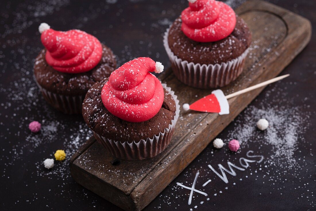 Christmas lingonberry and gingerbread cupcakes decorated with Father Christmas hats