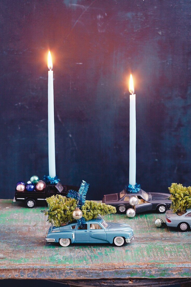 Toy cars as candle holders for Christmas decorations