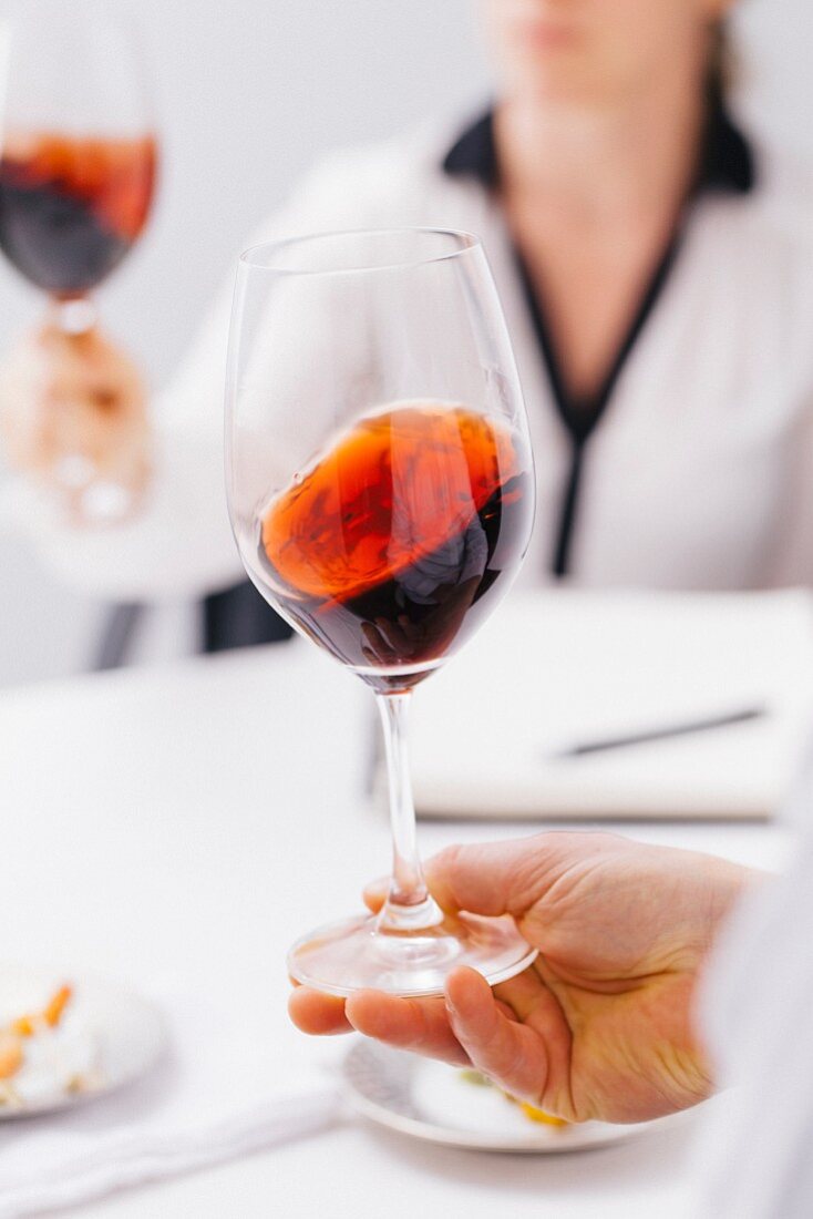 Swirling red wine in glass