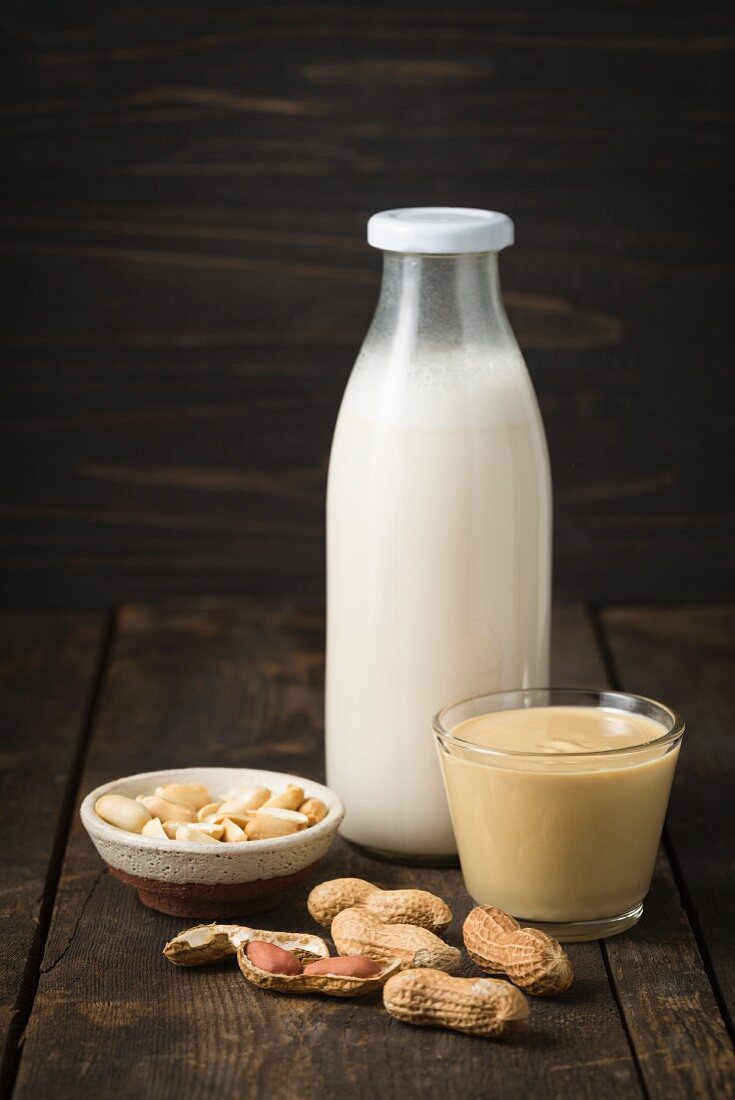 A jar of peanut mousse and peanut milk in a glass bottle