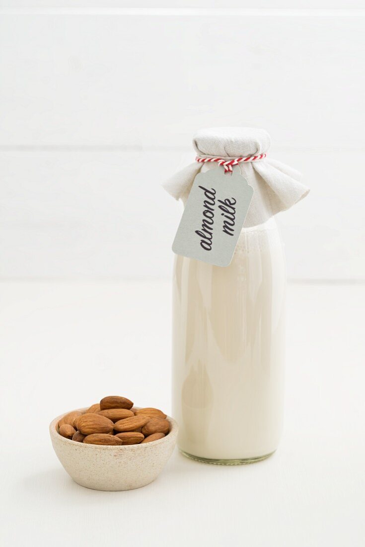 Almond milk in a glass bottle with a label