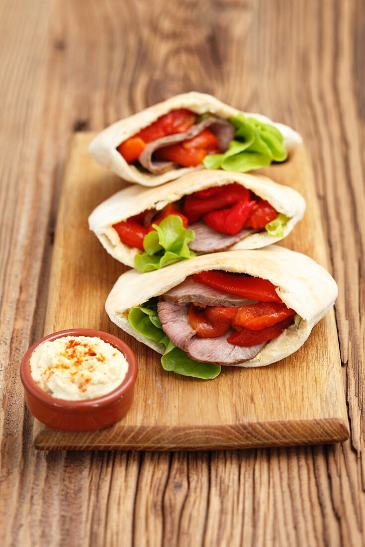 Pita pockets with roast beef and roasted peppers served with hummus