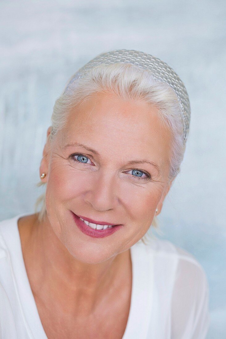 An older woman wearing a silver crocheted hat