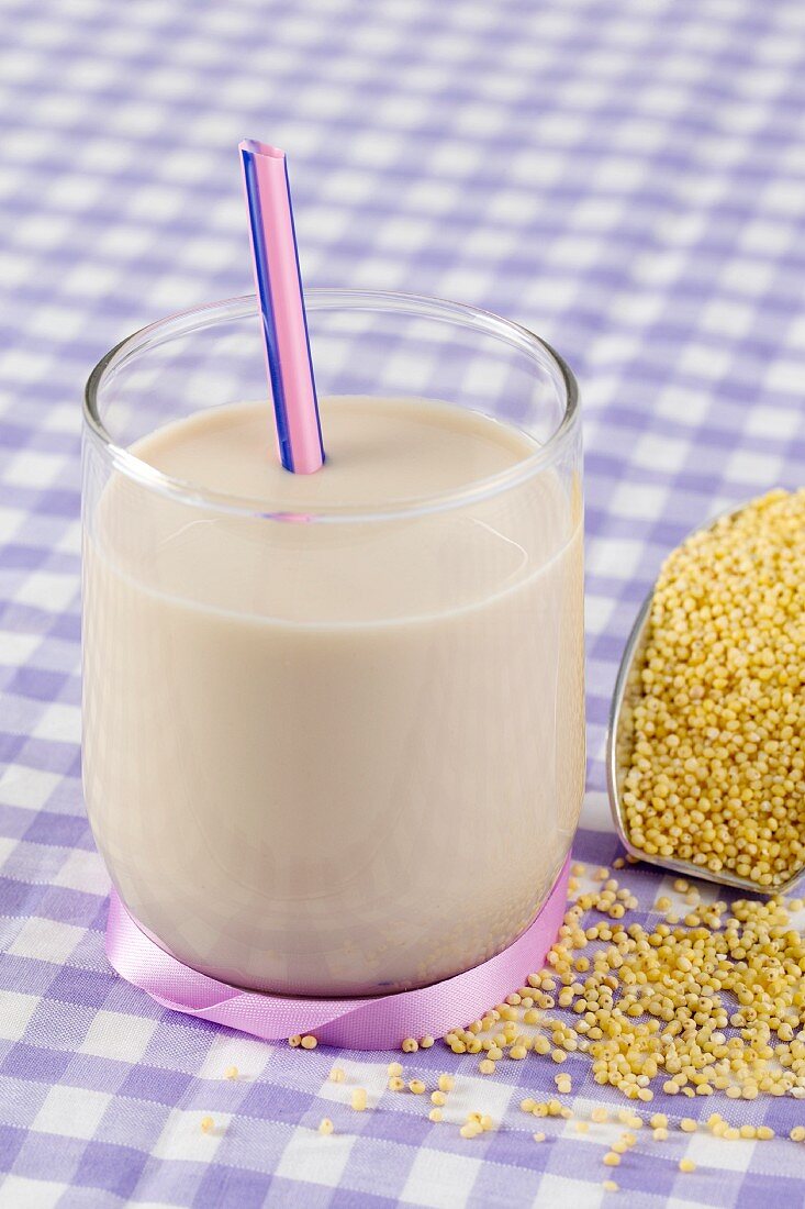 A glass of minutes milk and a scoop of millet