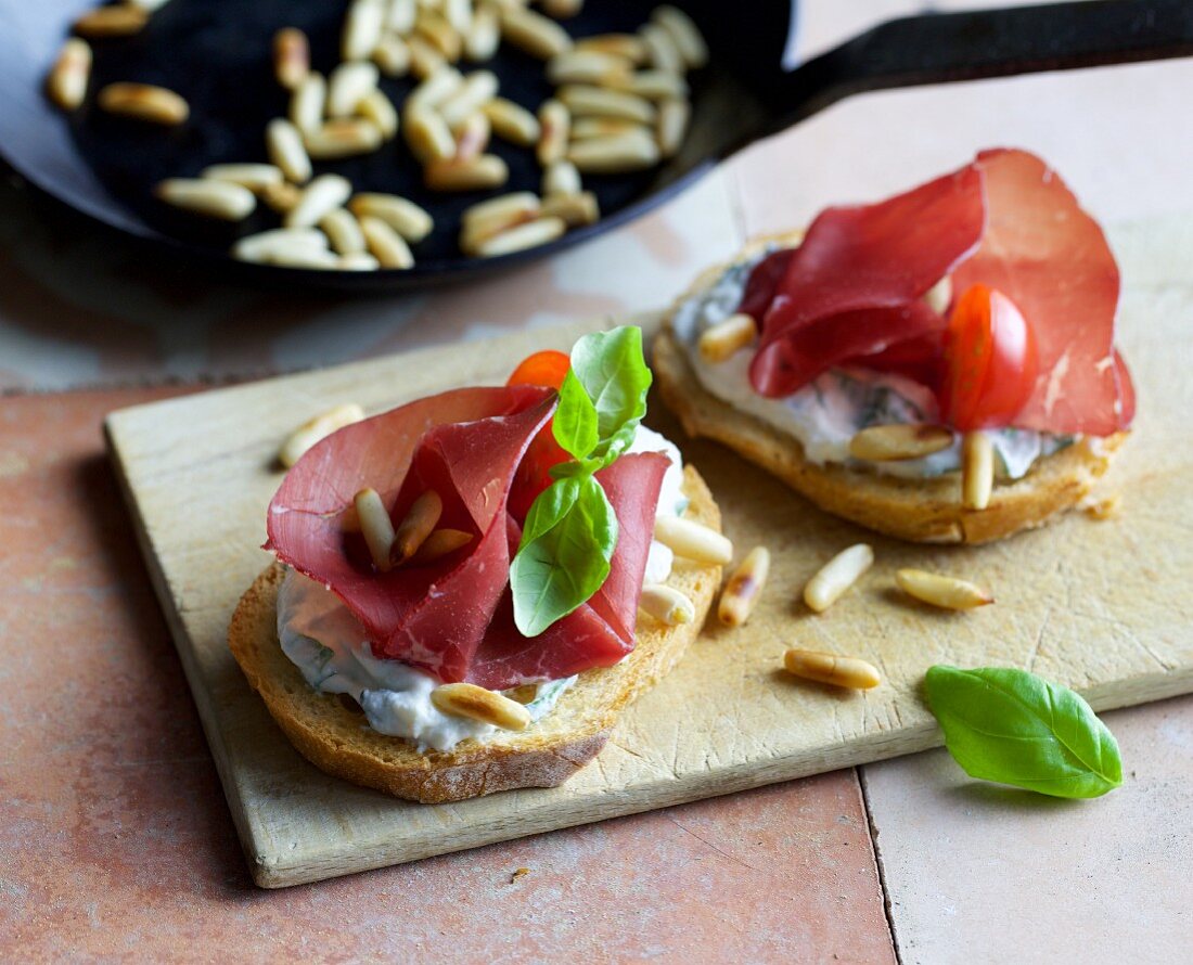 Crostini with ricotta, bresaola and pine nuts