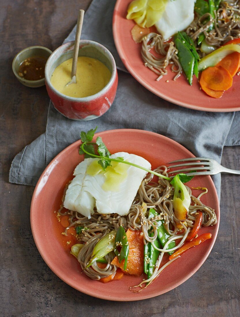 Steamed cod with soba noodles, vegetables and sesame seeds