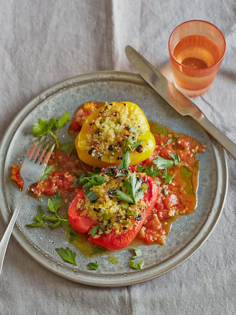 Peppers with a bulgur and olive filling on tomato sauce