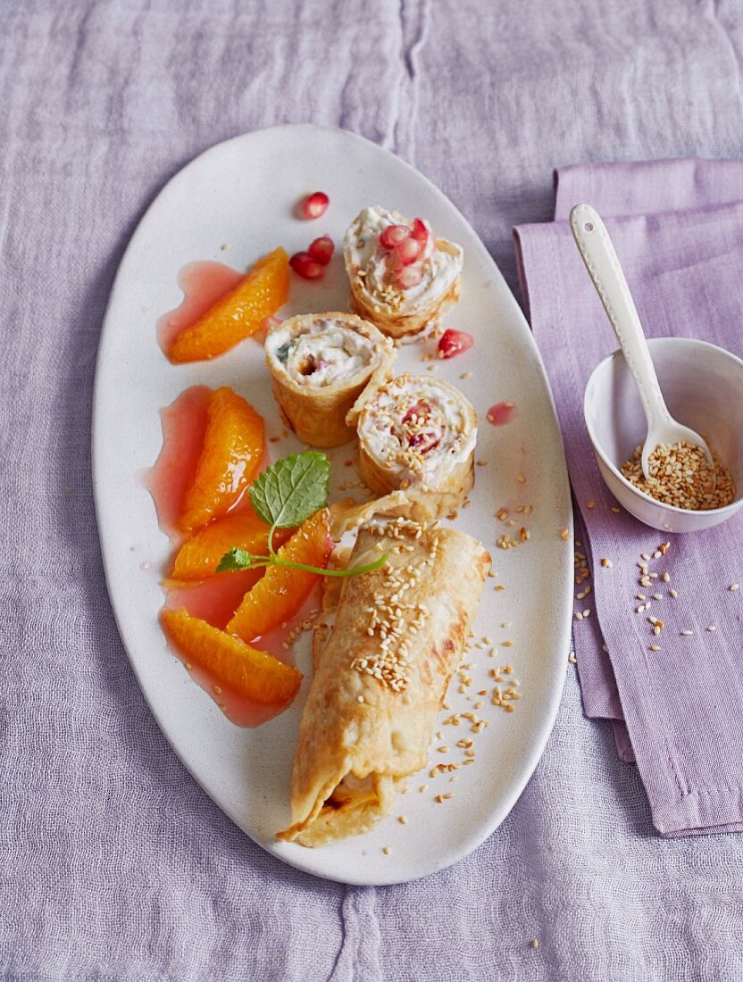 Sesame seed crepes filled with cream cheese and pomegranate seeds