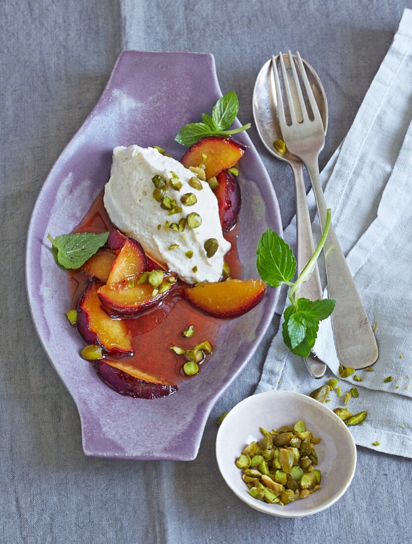 Honey-glazed plums with ginger and tofu cream and pistachio nuts