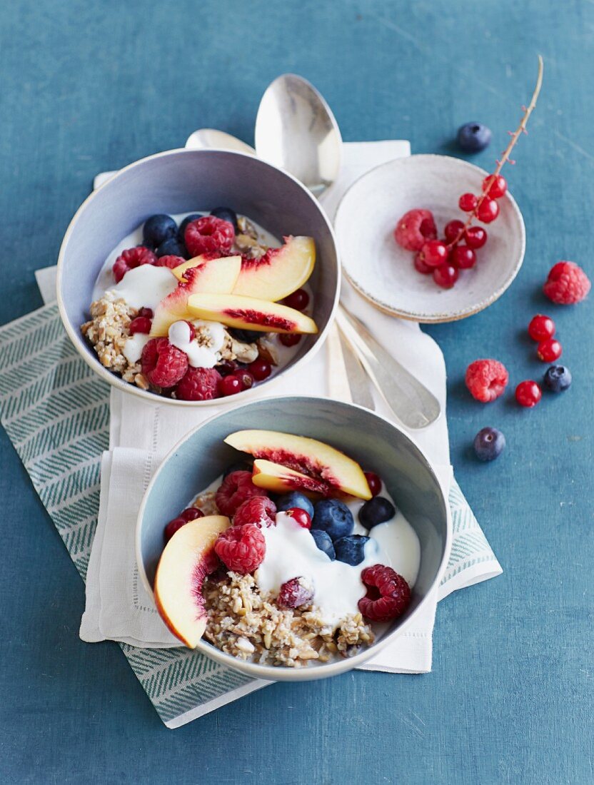 Fresh grain muesli with fresh summer fruits and vanilla yoghurt