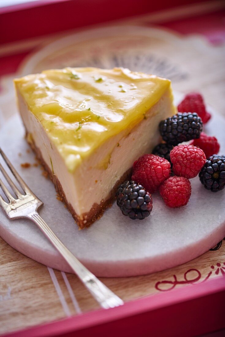 A slice of cheesecake with red berries