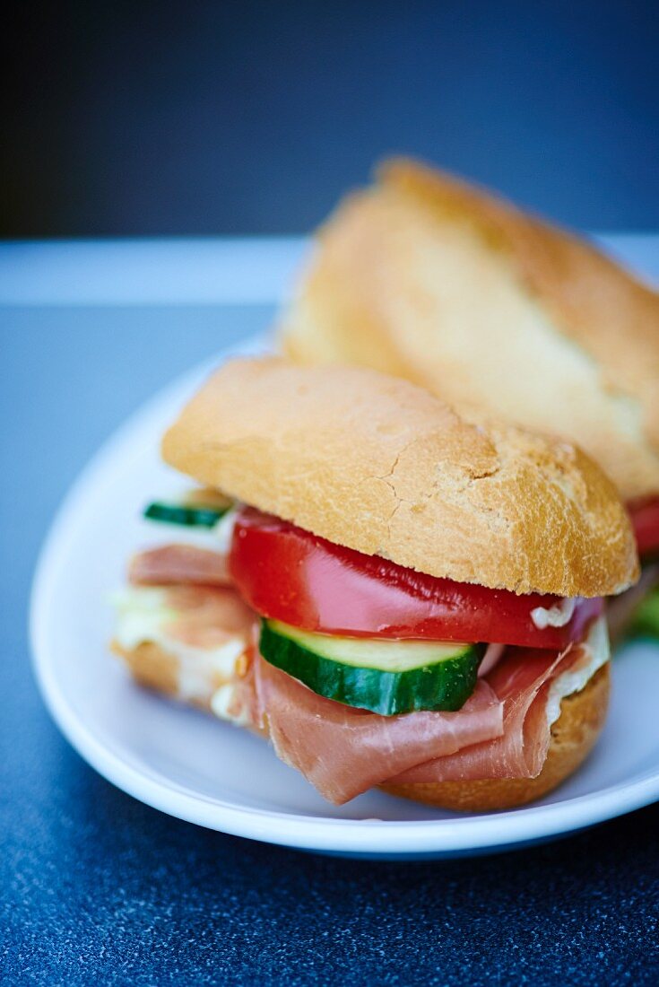 A ham sandwich with cucumber and tomato