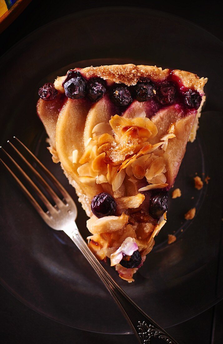 A slice of fruit tart with almonds