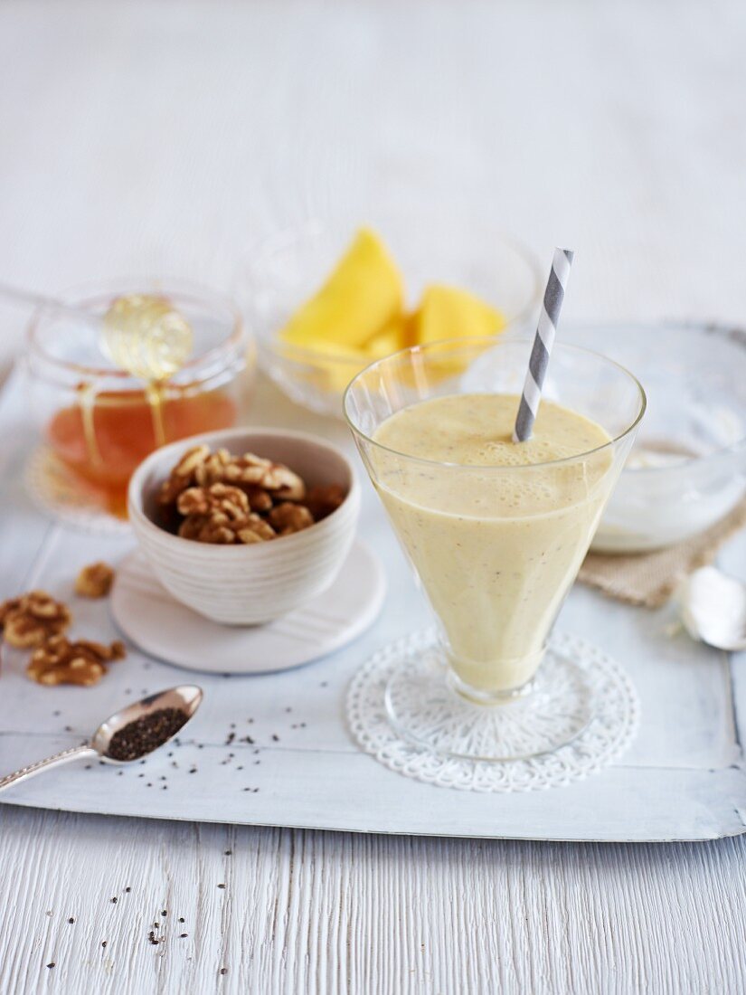 A mango shake with walnuts, chia seeds and honey