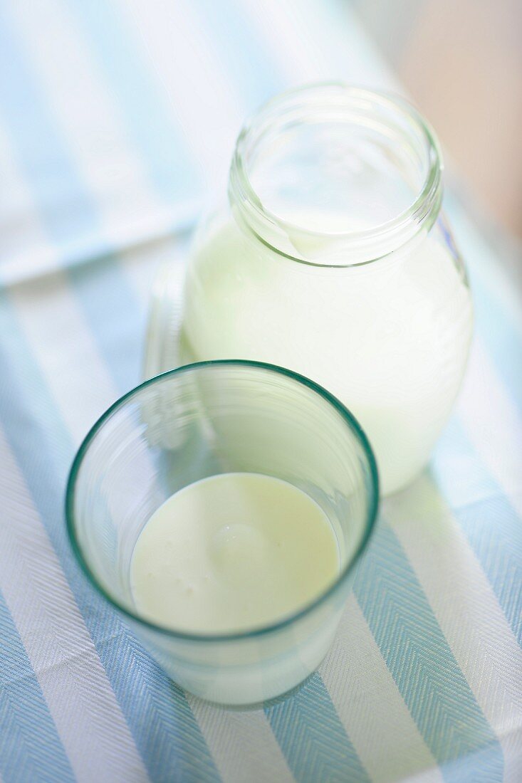Soured milk in a glass and in a bottle