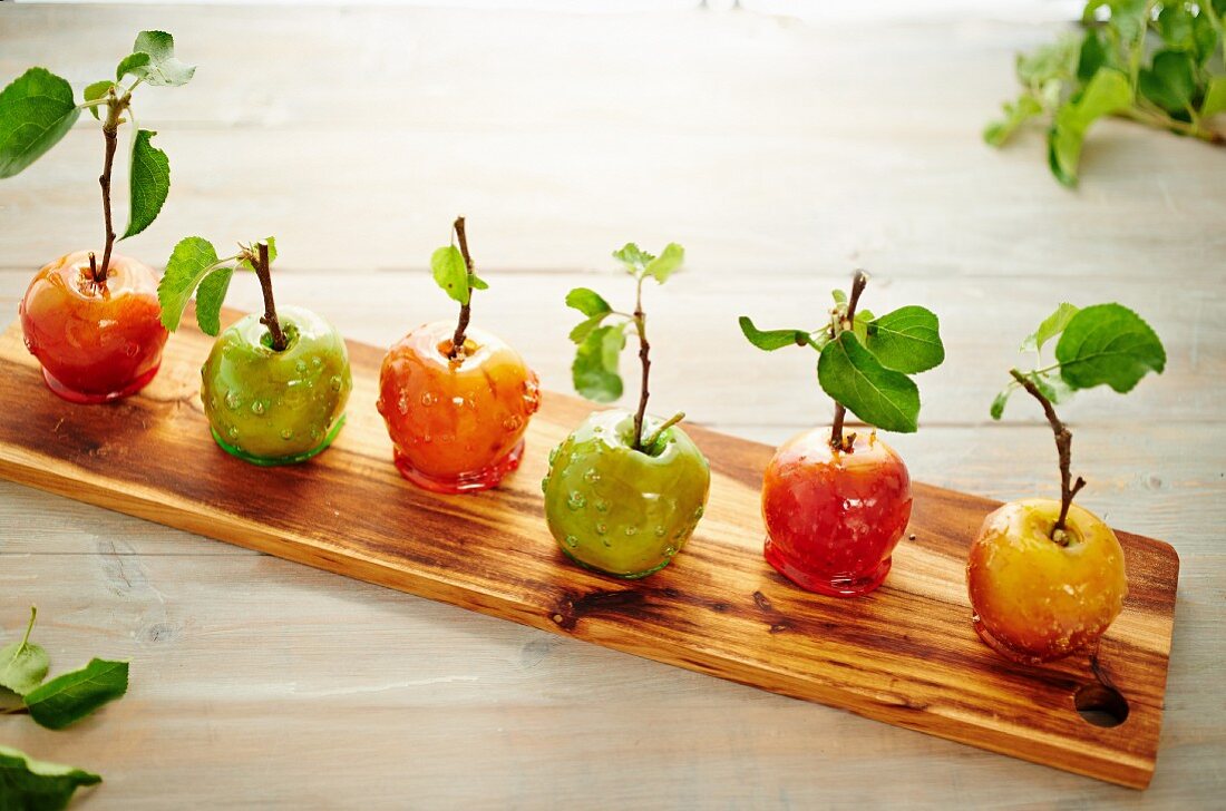 Rustic toffee apples on a wooden board