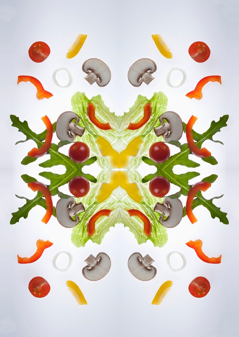 A digital composition of mirrored images of of a mixed vegetable salad