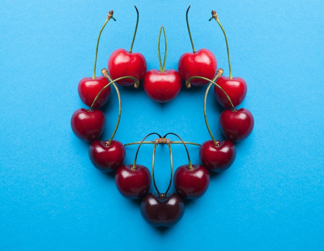 A digital composition of mirrored images of a cherry heart