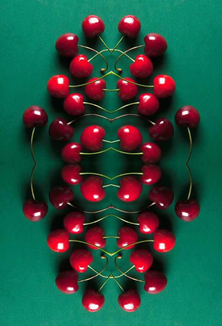 A digital composition of mirrored images of cherries