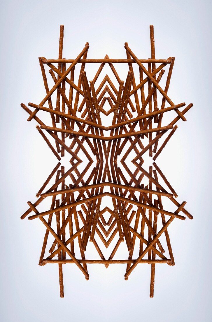 A digital composition of mirrored images of an arrangement of pretzel sticks
