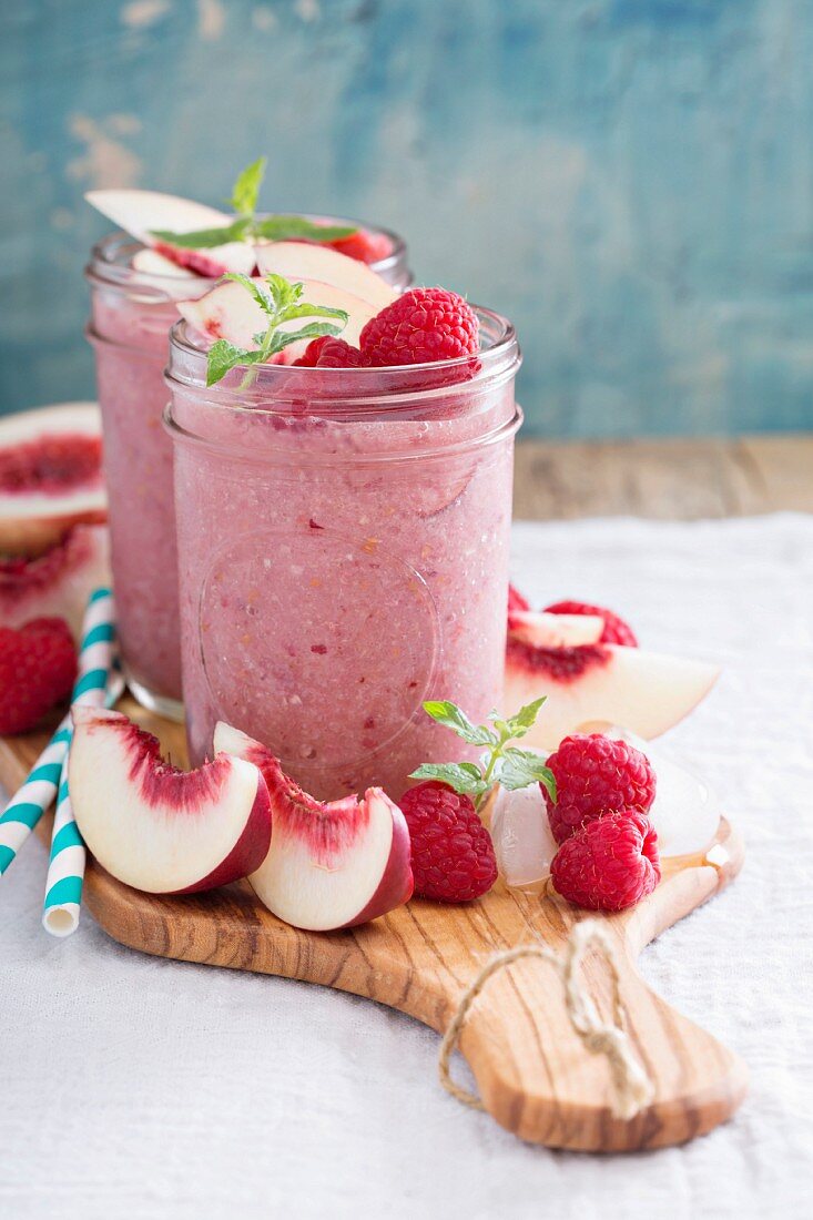 White peach and raspberry smoothie in preserving jars
